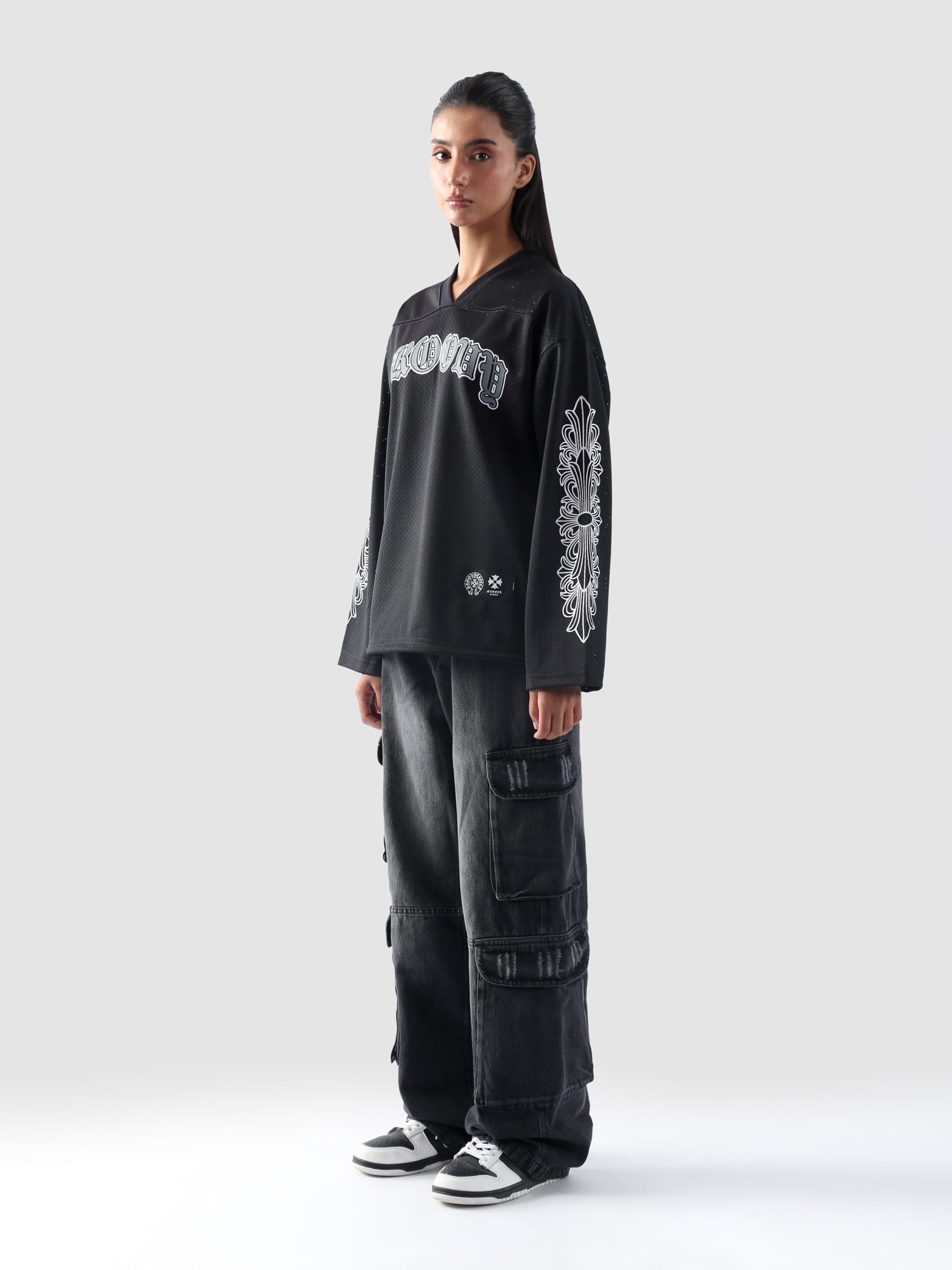 Front view of female model wearing GROOVY’s black full sleeves Chrome Hearts-inspired jersey.
