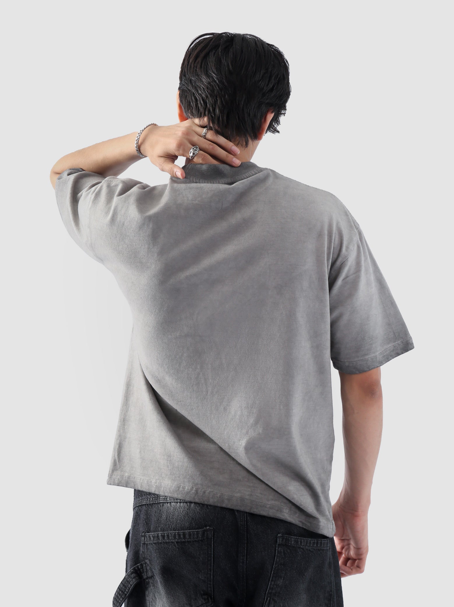 Rear view of the Oil Fade Blank t-shirt showcasing its clean silhouette and seamless gradient fade from stone grey to charcoal.
