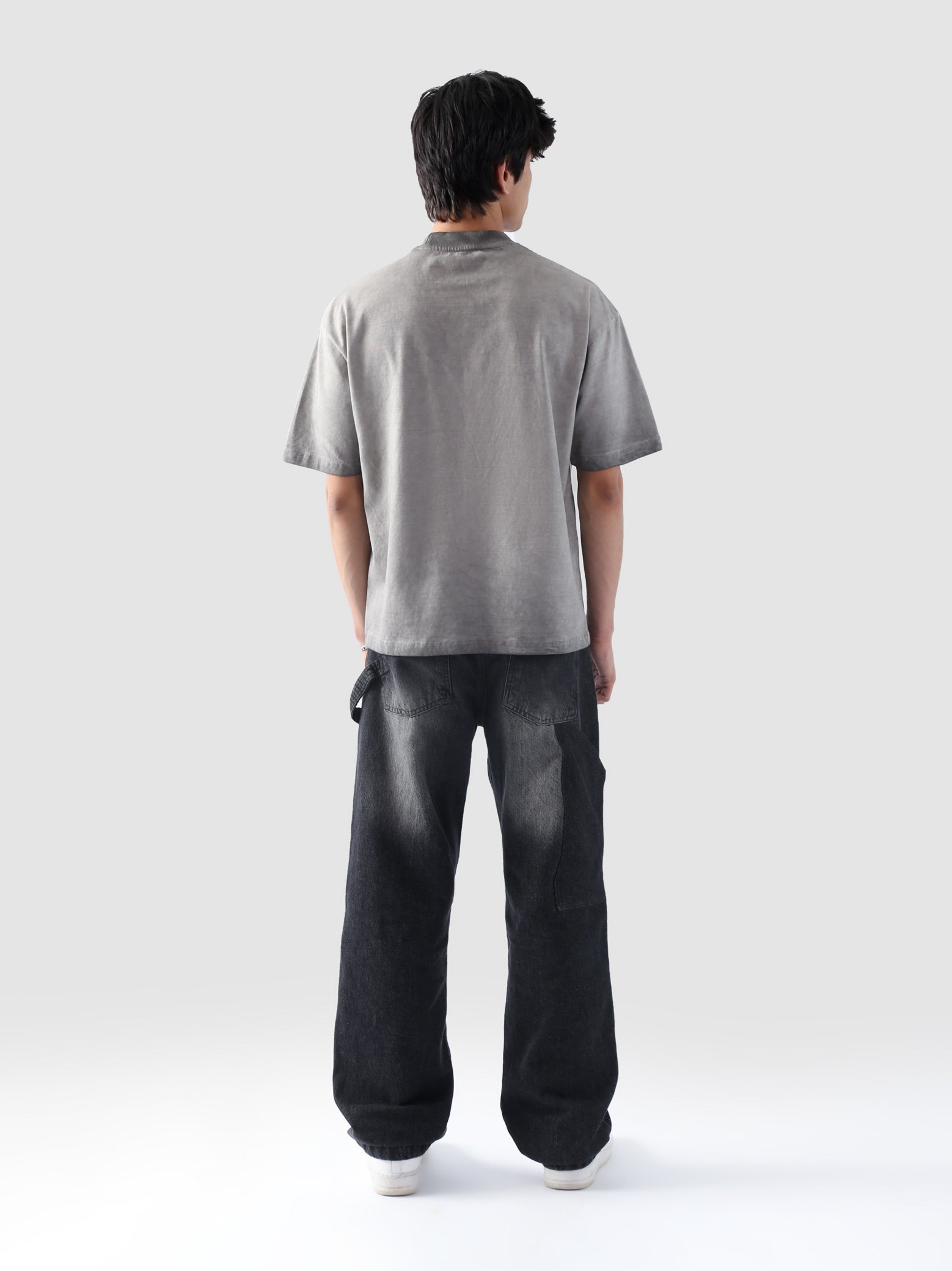 Rear view of the Oil Fade Blank t-shirt showcasing its clean silhouette and seamless gradient fade from stone grey to charcoal.
