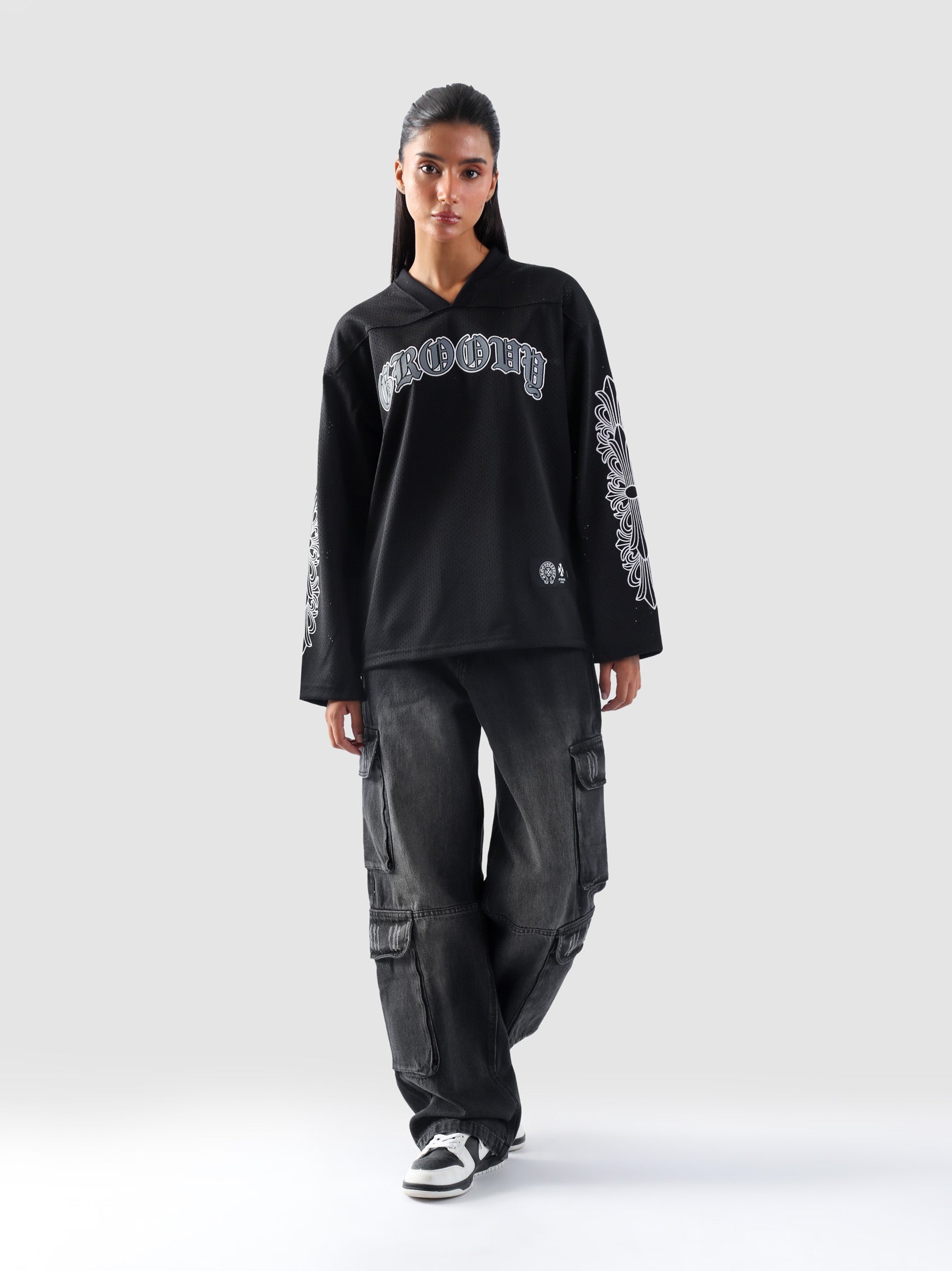 Front view of GROOVY's Chrome Hearts-inspired full sleeves jersey in gothic black with bold arm prints.