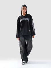 Front view of GROOVY's Chrome Hearts-inspired full sleeves jersey in gothic black with bold arm prints.