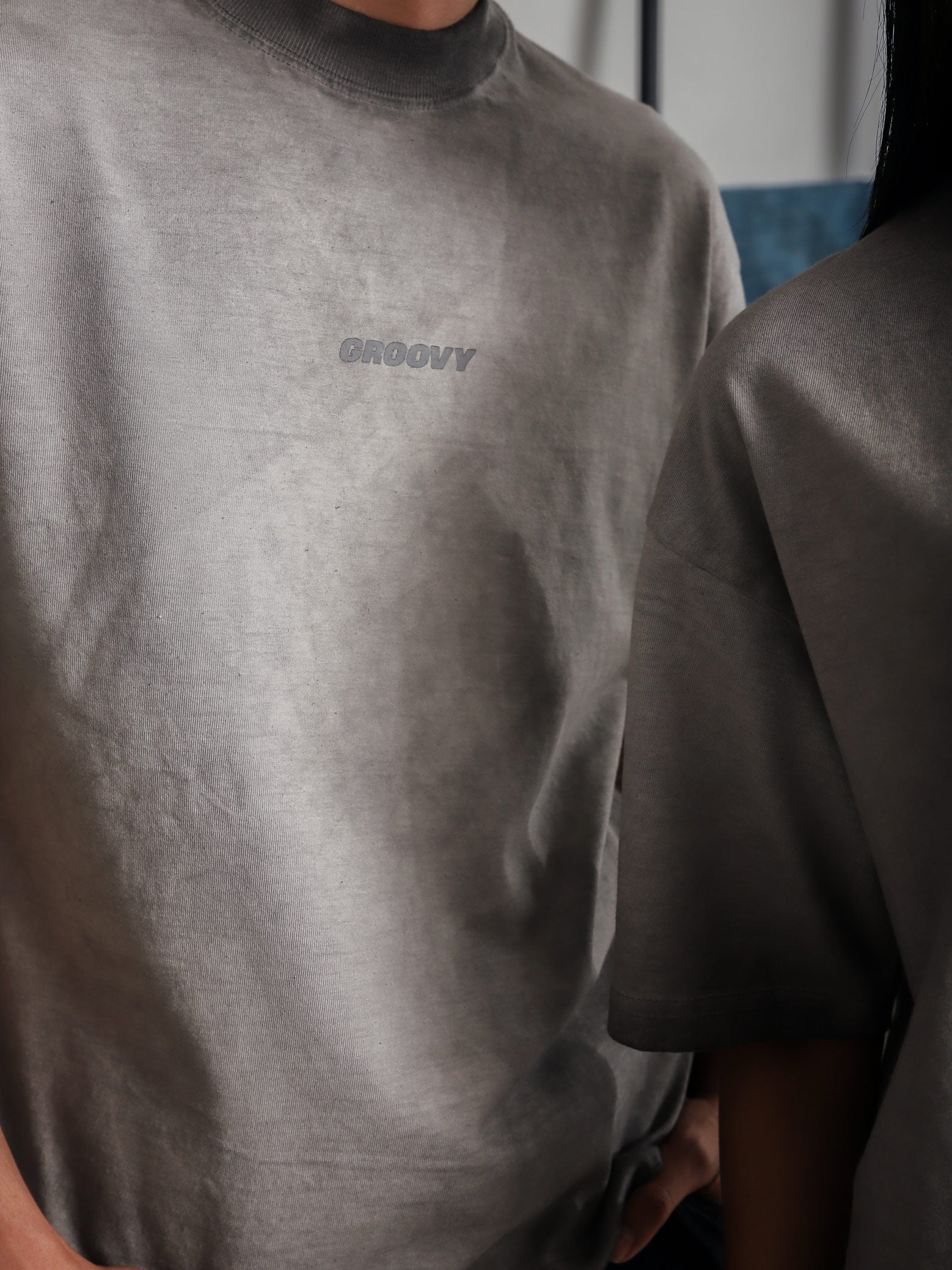 Close-up of GROOVY Oil Fade Blank t-shirt showing textured wash and centered screen-printed logo, highlighting the garment’s unique oil-infused fade.
