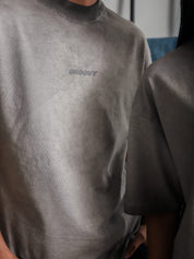 Close-up of GROOVY Oil Fade Blank t-shirt showing textured wash and centered screen-printed logo, highlighting the garment’s unique oil-infused fade.
