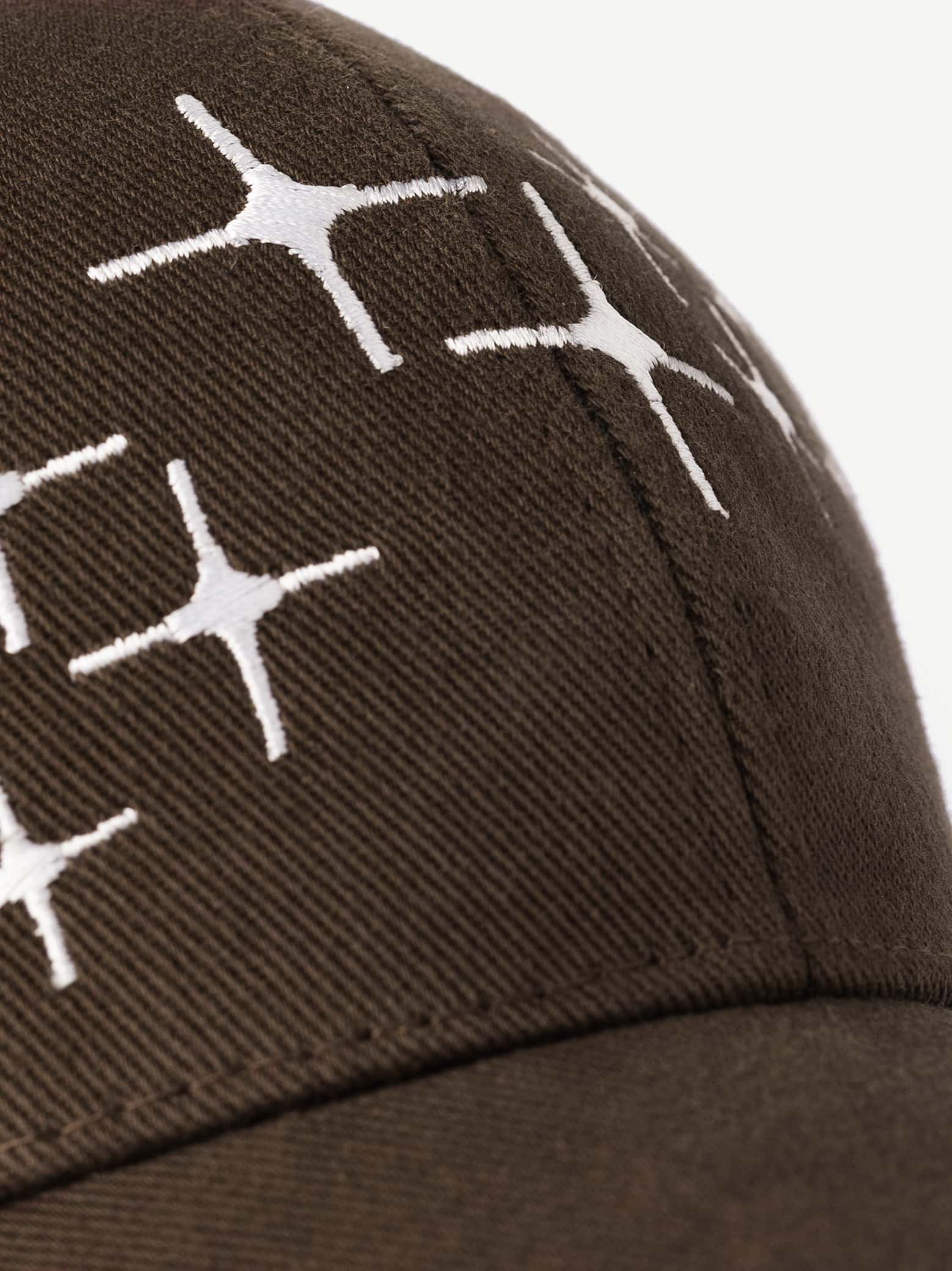 Brown cap with white geometric pattern on a light gray background