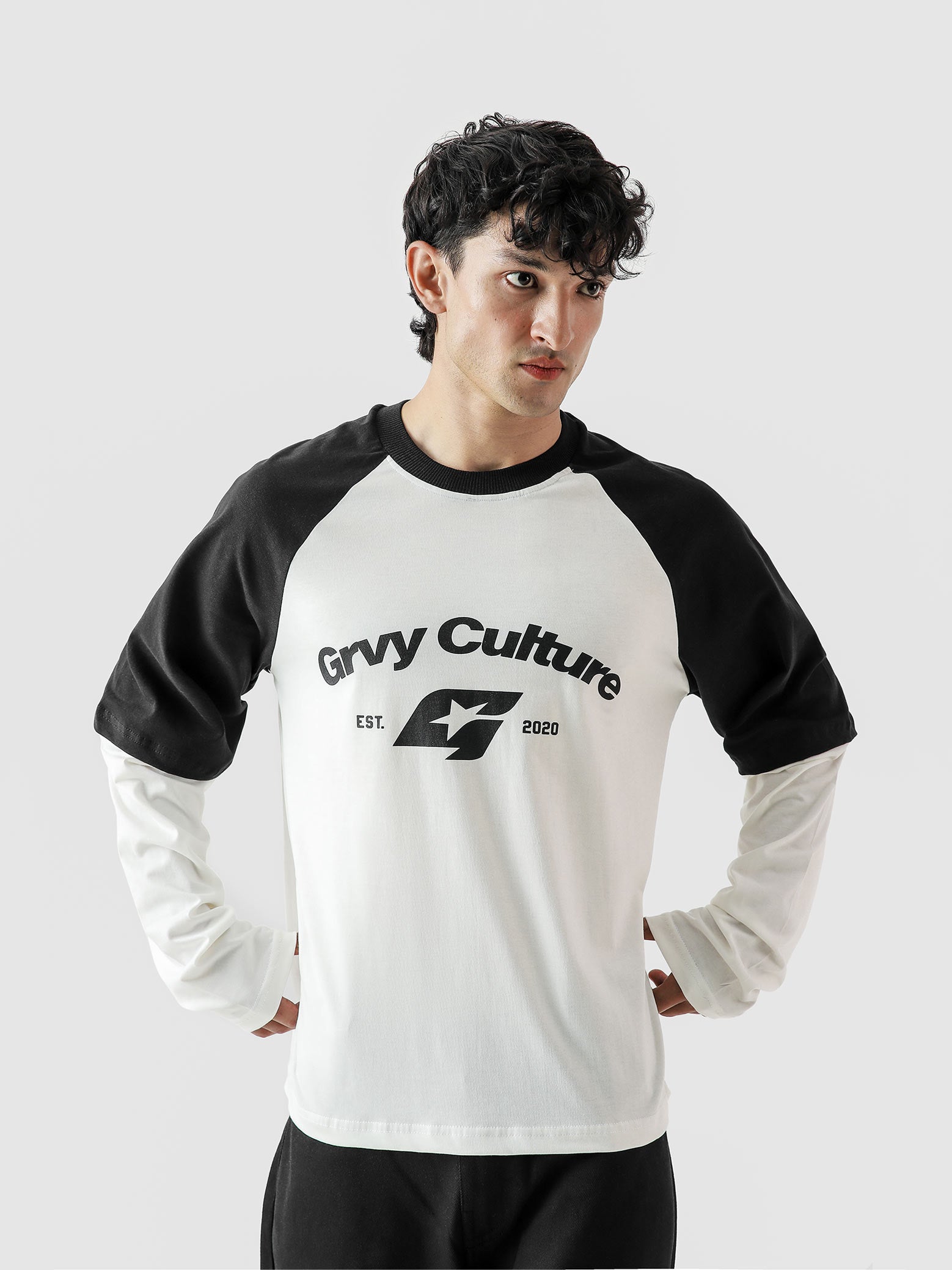 Person wearing a black and white 'Grvy Culture' long-sleeve shirt on a light gray background