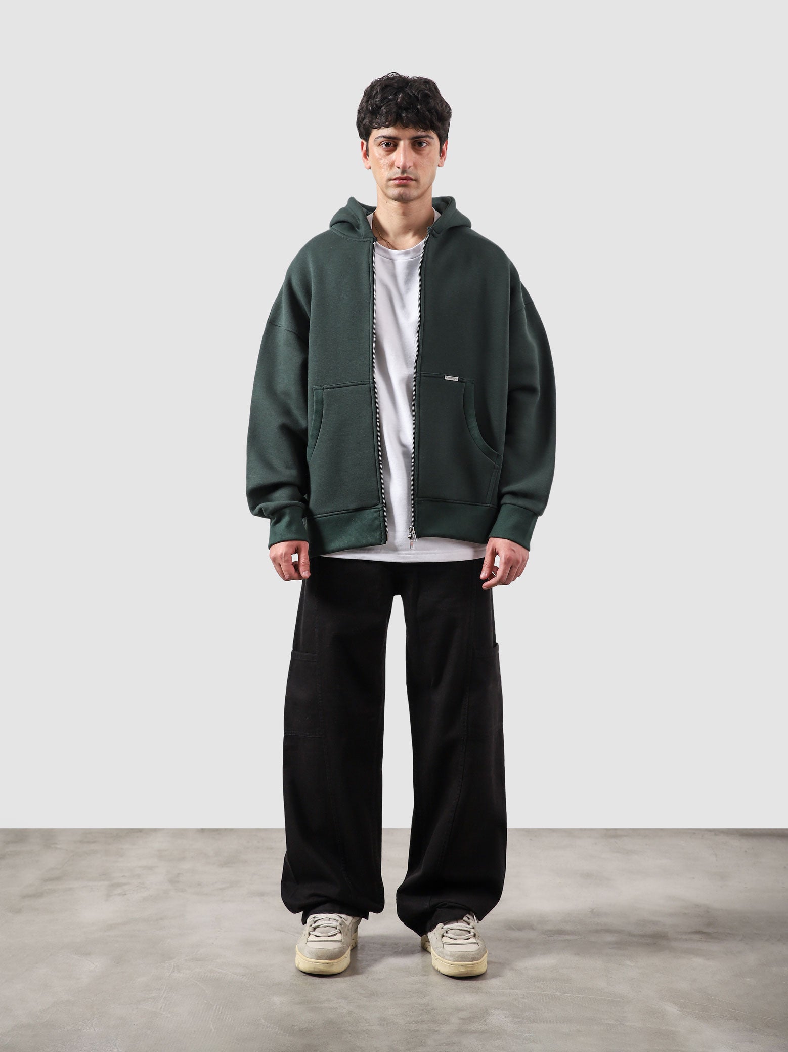 Racing green essential zipper hoodie male model full body front view Pakistan – GROOVY