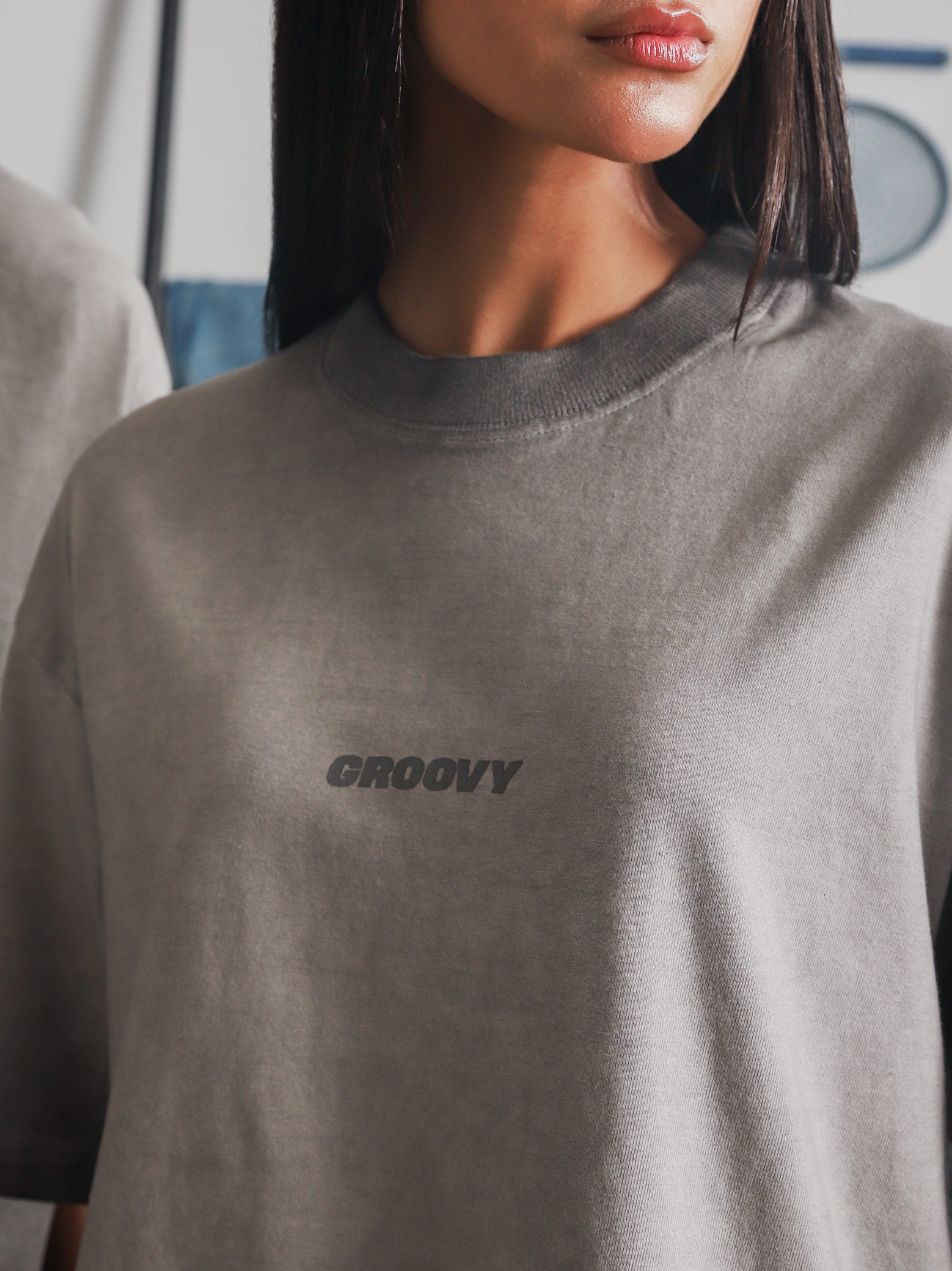 Close-up of the Oil Fade Blank t-shirt showcasing the subtle GROOVY logo and signature oil-washed gradient texture.
