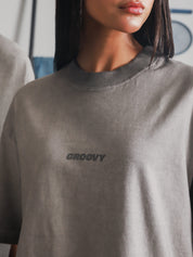 Close-up of the Oil Fade Blank t-shirt showcasing the subtle GROOVY logo and signature oil-washed gradient texture.
