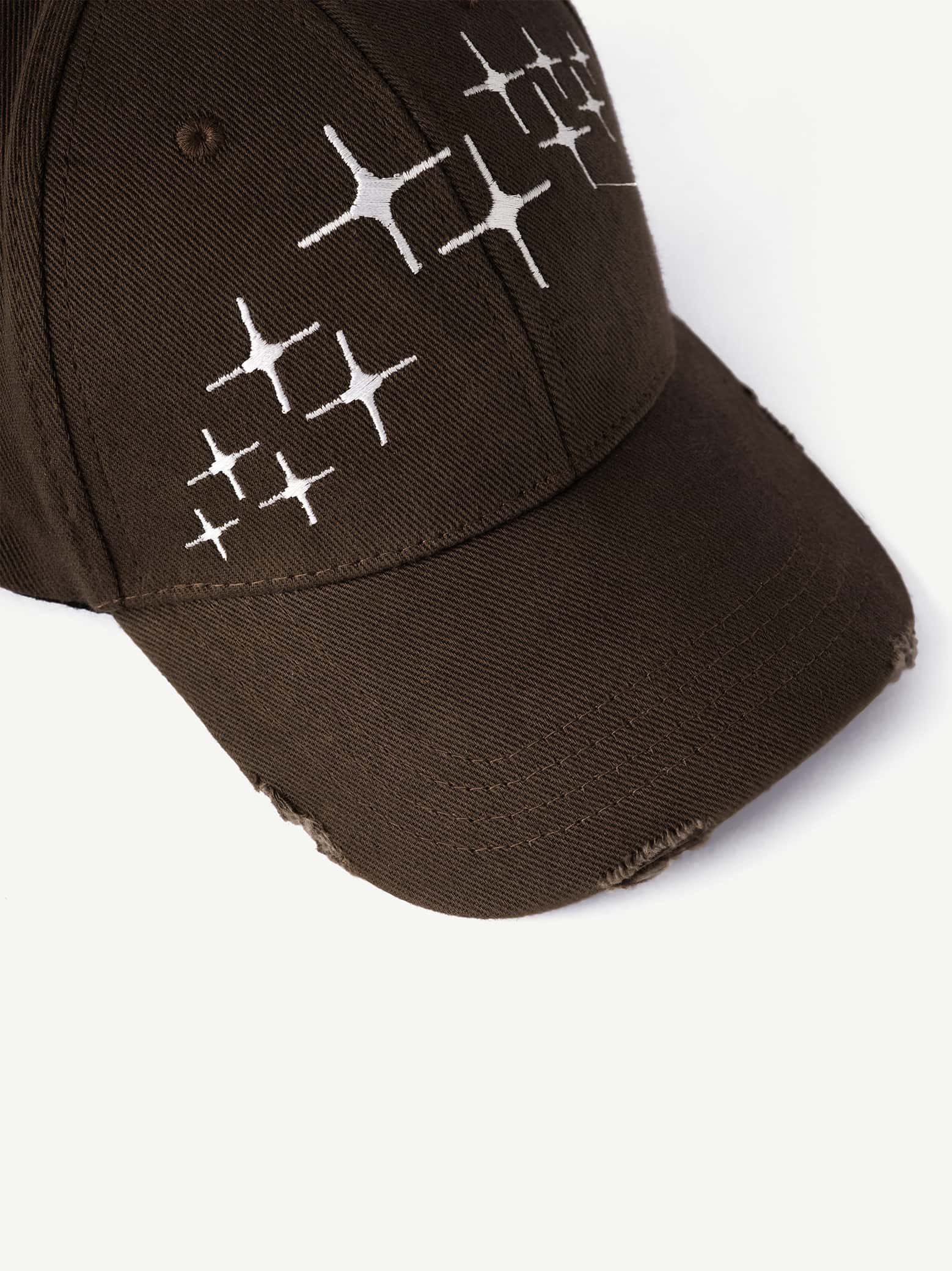Brown cap with white geometric patterns on a white background