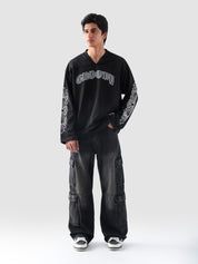Side pose showcasing the full sleeves of the GROOVY Chrome Hearts black jersey with intricate sleeve print.
