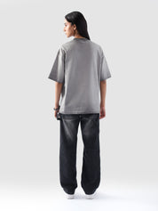 Rear view of the Oil Fade Blank t-shirt showcasing its clean silhouette and seamless gradient fade from stone grey to charcoal.

