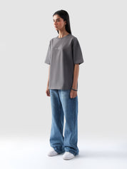 Woman wearing grey oversized t-shirt with 'Zero to One' print – unisex streetwear in Pakistan by Groovy