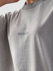 Close-up of the Oil Fade Blank t-shirt showcasing GROOVY’s signature logo screen-printed on the chest and the garment’s unique textured oil-washed finish.
