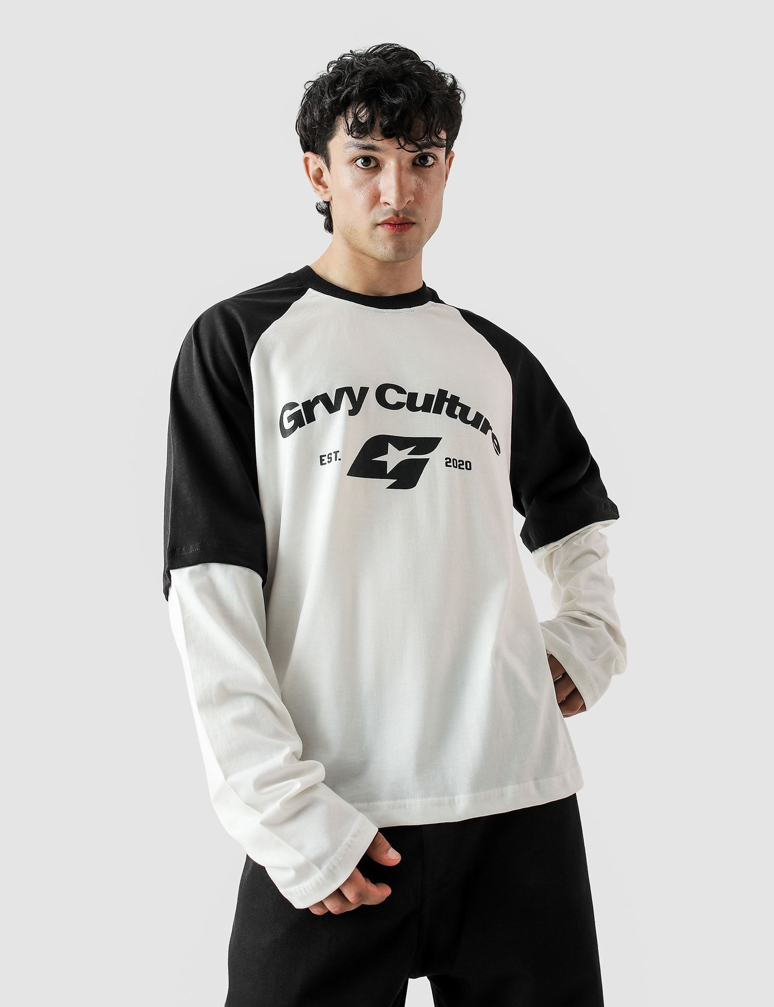 Person wearing a black and white long-sleeve shirt with 'Gryv Culture' logo on a light gray background