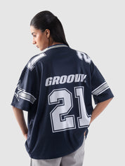 Full-body shot of female model walking forward in the All Stars Basketball Jersey and light cargo pants on a clean white background.