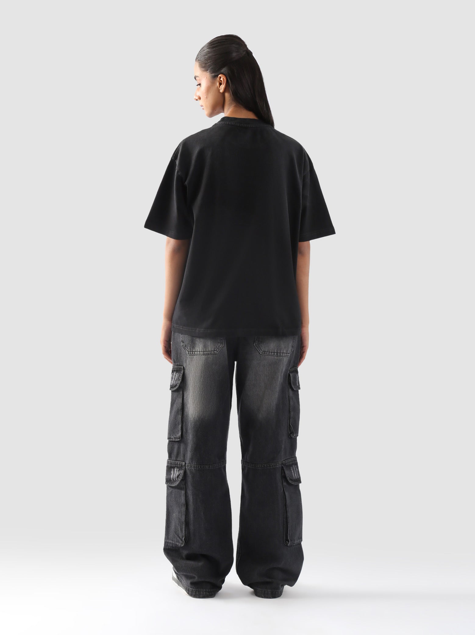 Back view of the black oversized "GROOVY Energy" t-shirt highlighting the clean minimal finish – streetwear for men and women in Pakistan.