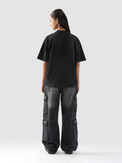 Back view of the black oversized "GROOVY Energy" t-shirt highlighting the clean minimal finish – streetwear for men and women in Pakistan.
