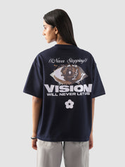 back view of a model wearing the "Never Stopping Culture" tee in navy blue. The oversized fit and front graphic featuring a bold star and "CLTR" text evoke a strong streetwear identity rooted in hustle and ambition.