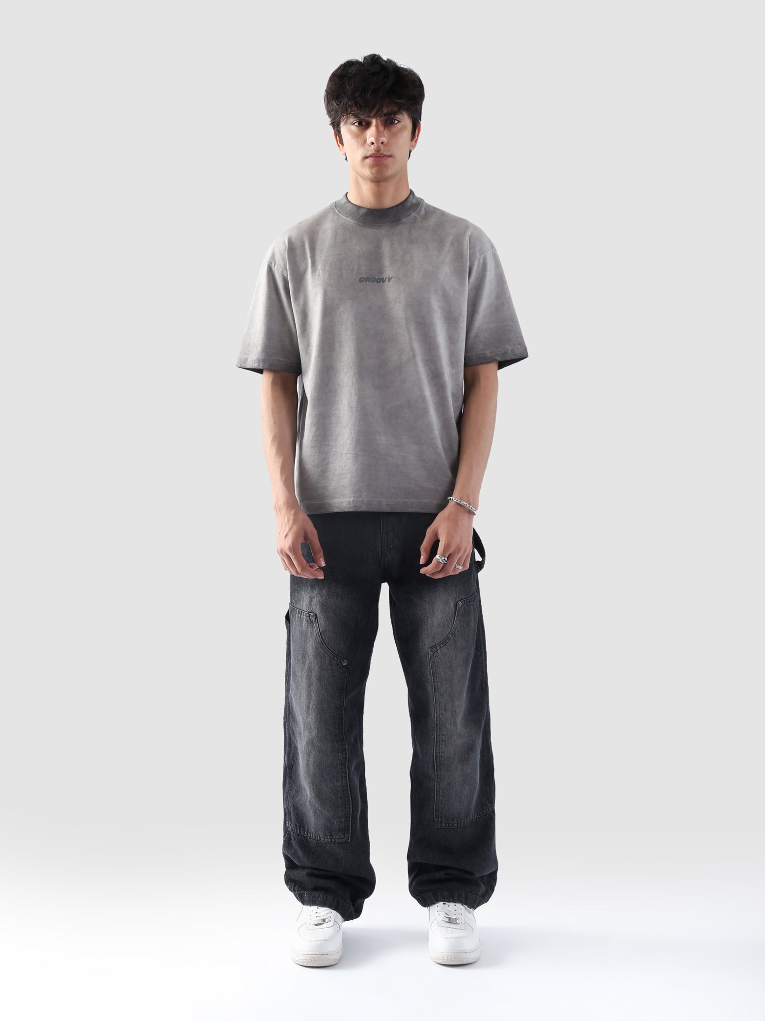 Front-facing view of the Oil Fade Blank t-shirt styled on a male model, highlighting the garment’s structured drop shoulder, relaxed silhouette, and signature faded wash.
