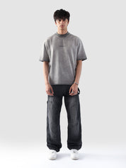 Front-facing view of the Oil Fade Blank t-shirt styled on a male model, highlighting the garment’s structured drop shoulder, relaxed silhouette, and signature faded wash.
