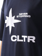 Close-up of the front design on the "Never Stopping Culture" navy blue tee, featuring a bold white starburst graphic with the words “NEVER STOPPING” and “CLTR” in contrasting puff print – symbolizing resilience and forward movement.