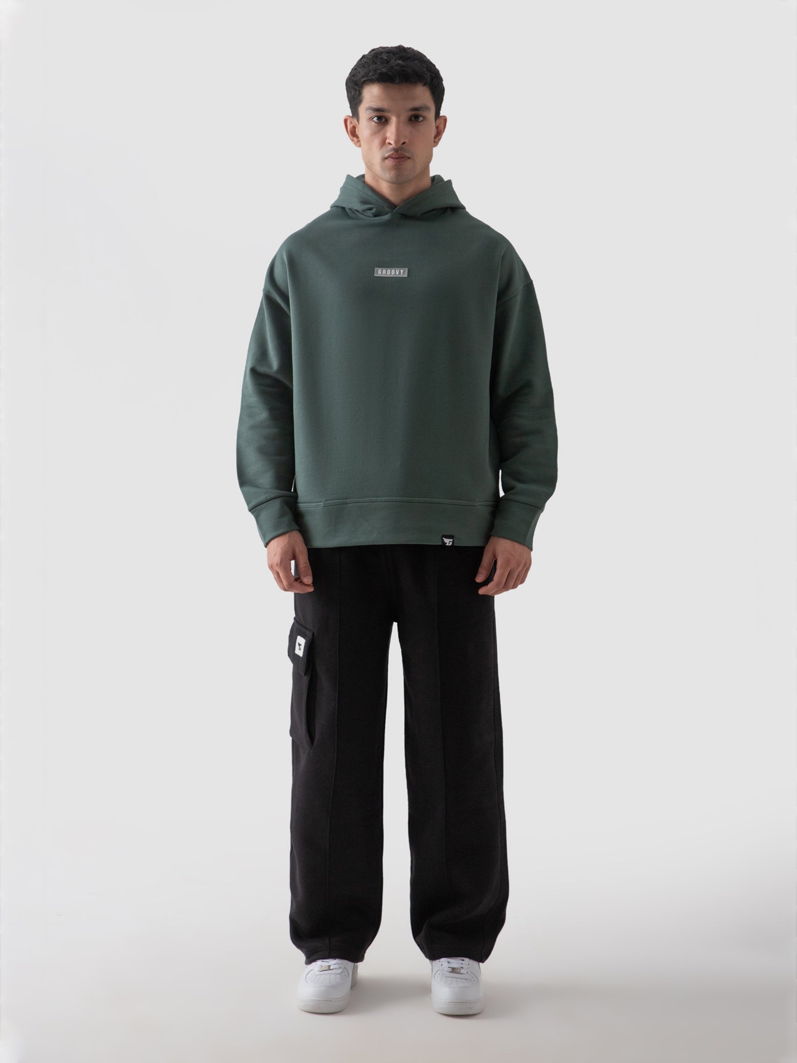 Hunter green hoodie male model half body lifestyle shot Pakistan – GROOVY