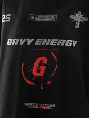 Close-up of "GROOVY Energy" t-shirt featuring silver and red graphic print and slogan “The Best is Yet to Come” – urban streetwear detail.
