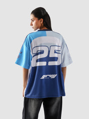 Back view of woman wearing oversized racing jersey with number 25 and Groovy Culture logo – indoor lifestyle streetwear shoot in Pakistan
