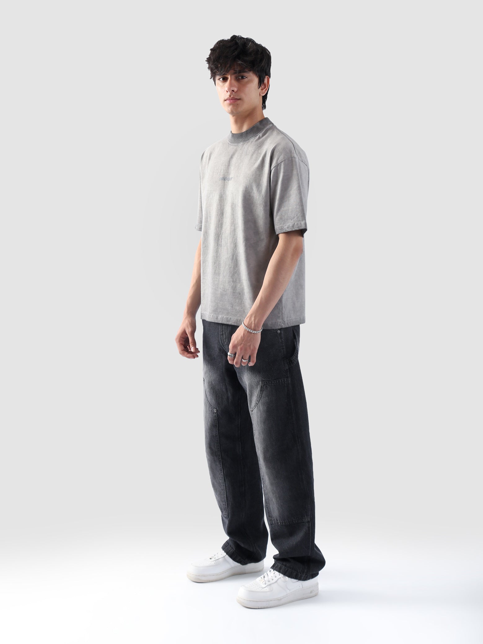 Front-facing view of the Oil Fade Blank t-shirt styled on a male model, highlighting the garment’s structured drop shoulder, relaxed silhouette, and signature faded wash.
