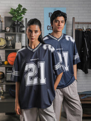 Female and male model both wearing GROOVY All Stars Basketball Jersey, styled with cargo pants, posed in an indoor sports-inspired setup.
