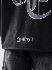Back lower hem detail of GROOVY's Chrome Hearts jersey showcasing GRVYCLUB label design.