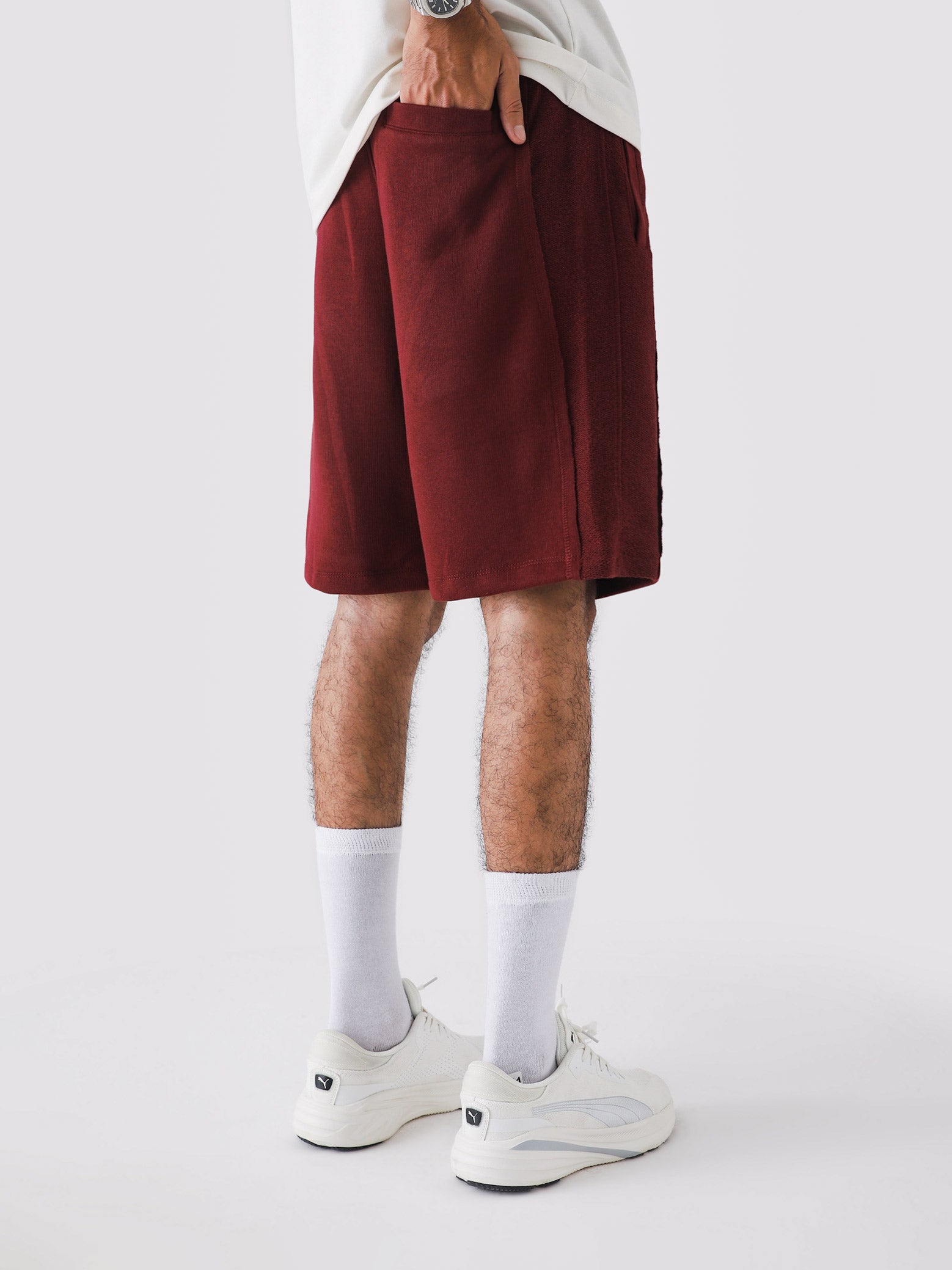 Wine Red Aim Shorts on model, relaxed-fit men's gym and casual shorts by GROOVY Pakistan