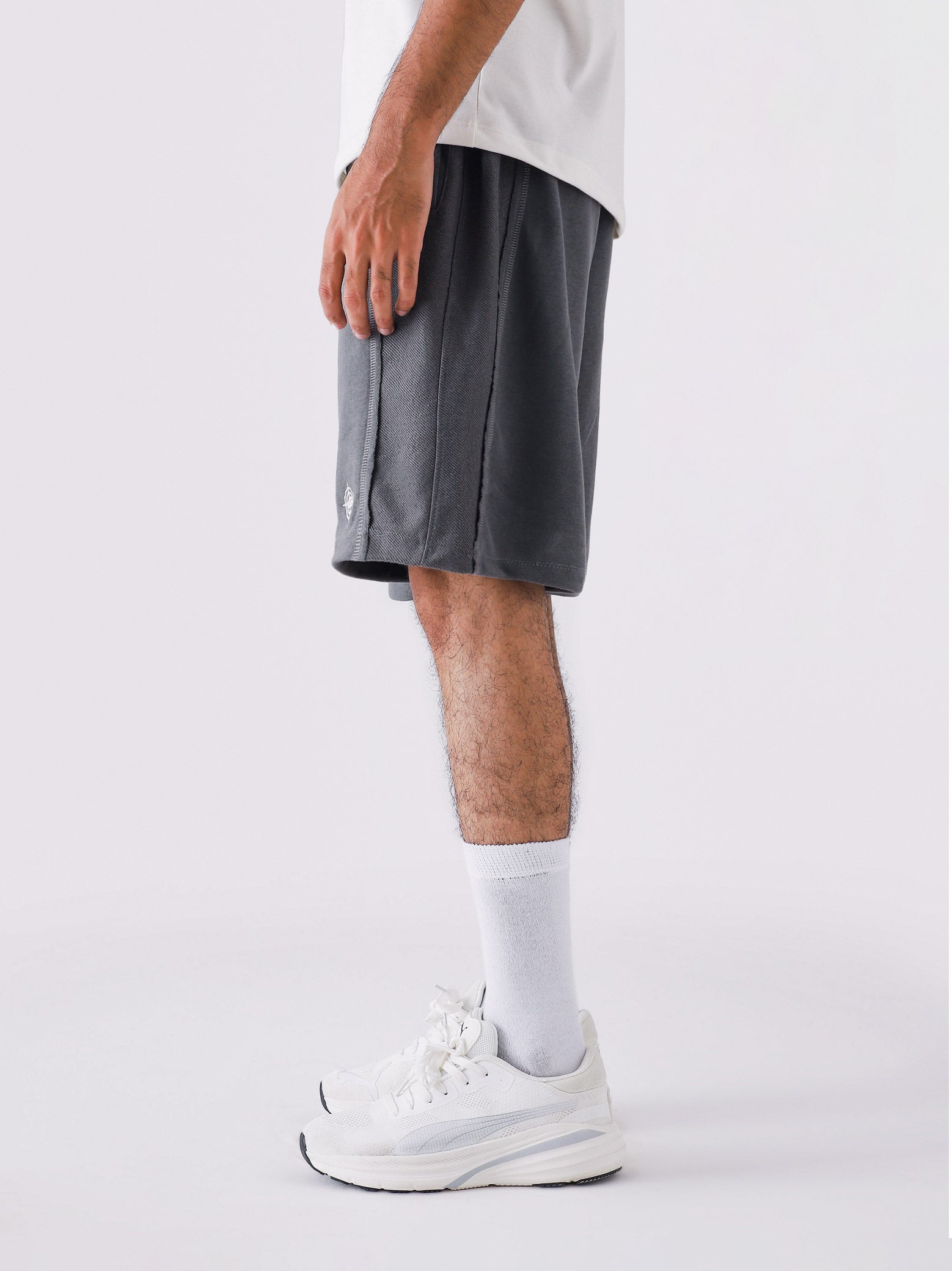 Man wearing Graphite Grey Aim Shorts, GROOVY men's sport and lounge shorts, Pakistan streetwear