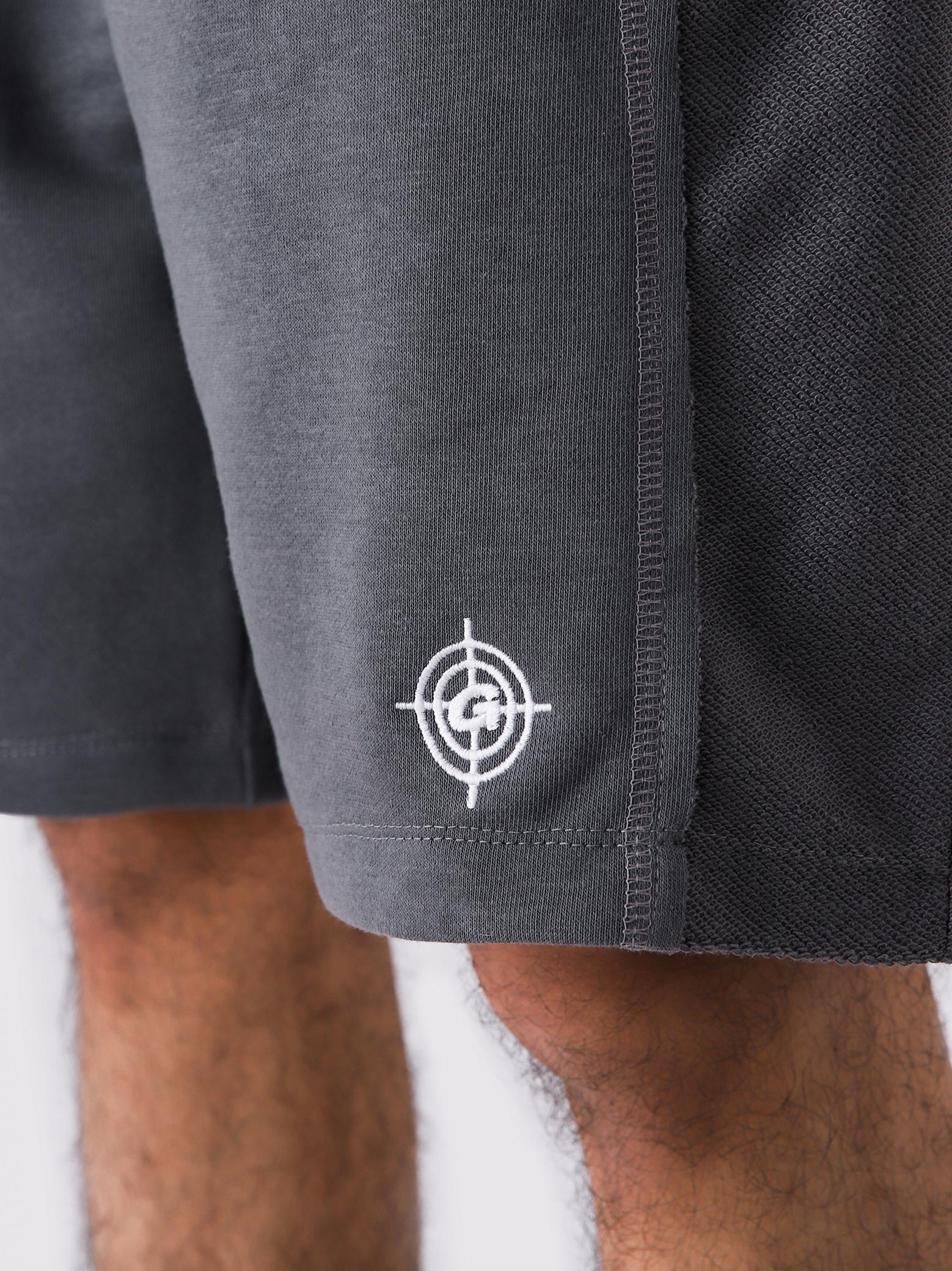Graphite Grey Aim Shorts on model, relaxed-fit men's gym and casual shorts by GROOVY Pakistan