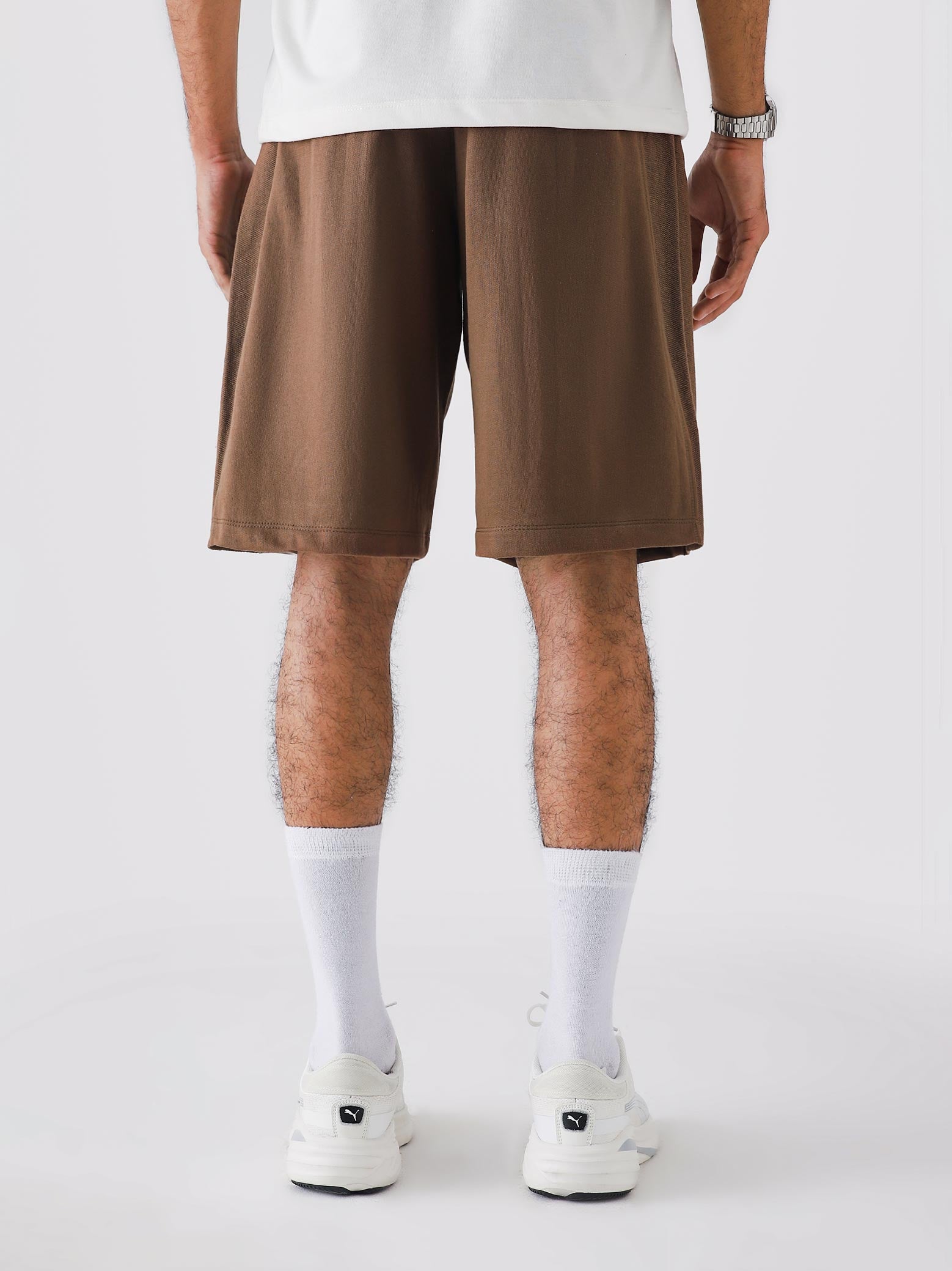 Chocolate Brown Aim Shorts on model, relaxed-fit men's gym and casual shorts by GROOVY Pakistan