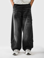 Mineral washed black star trousers front view - Distressed Star Pants | GROOVY Pakistan