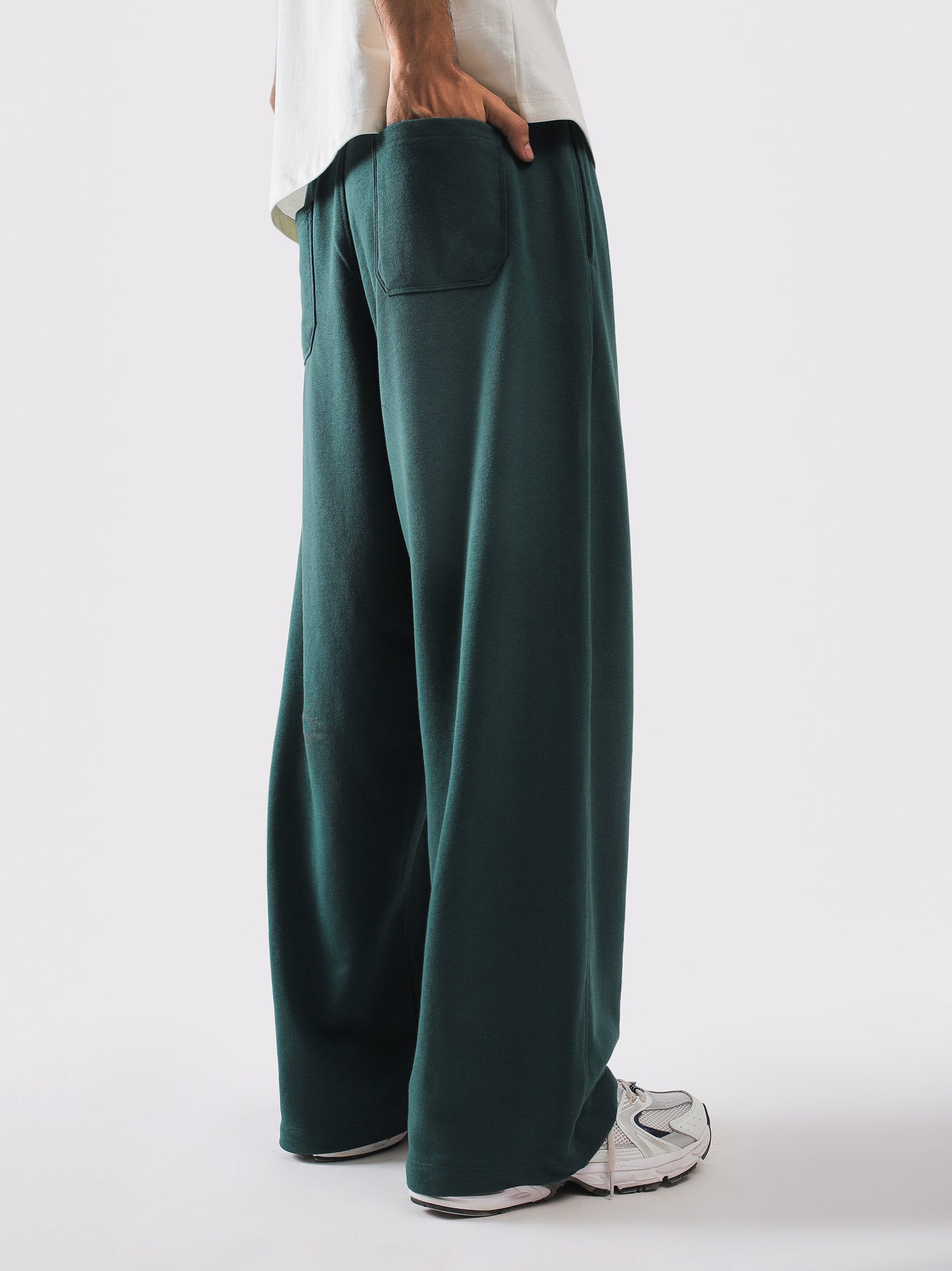 Deep green sweatpants styled with a cream tee - GROOVY Pakistan