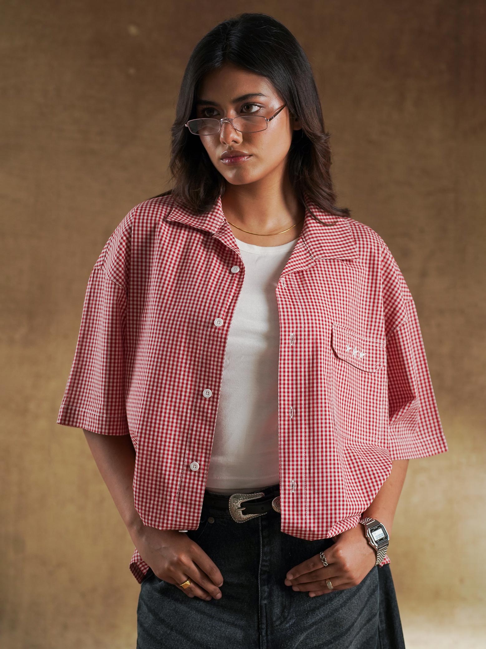 Red gingham shirt worn open over a white tank - GROOVY Pakistan