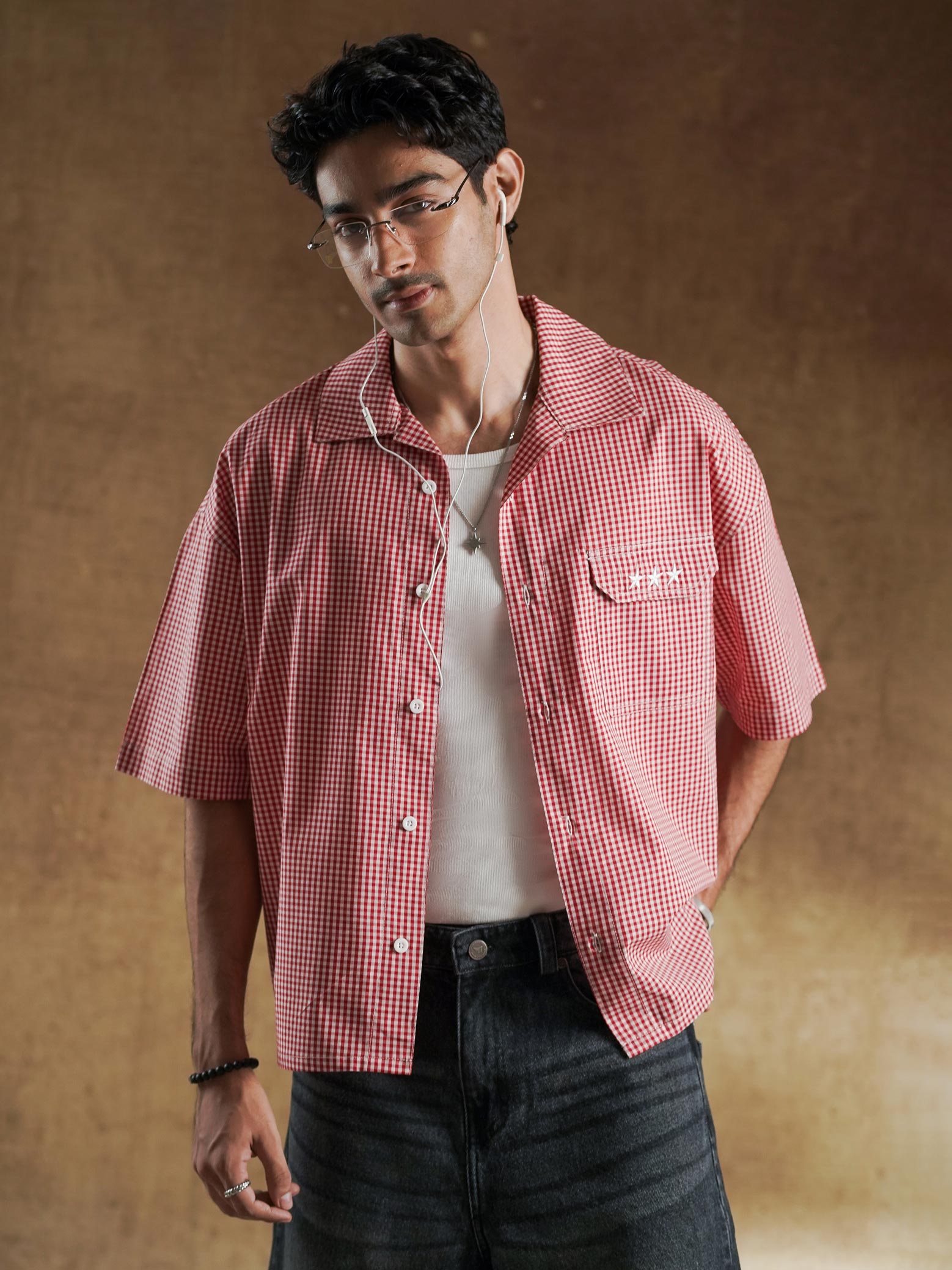 Puff embroidered GrvyStudios script across the back of a red gingham shirt - GROOVY Pakistan
