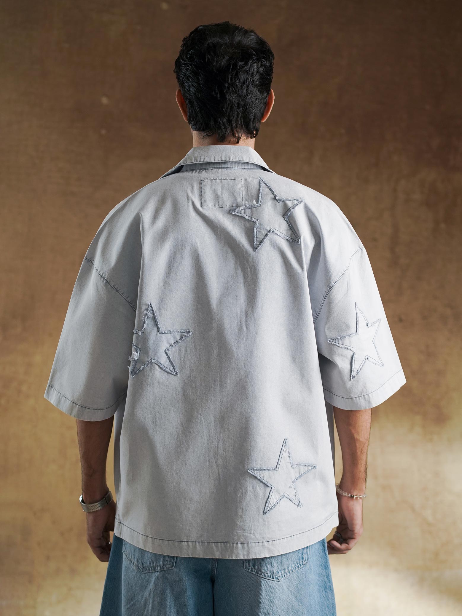 Sleeve cuff and star detail on washed denim shirt - GROOVY Pakistan