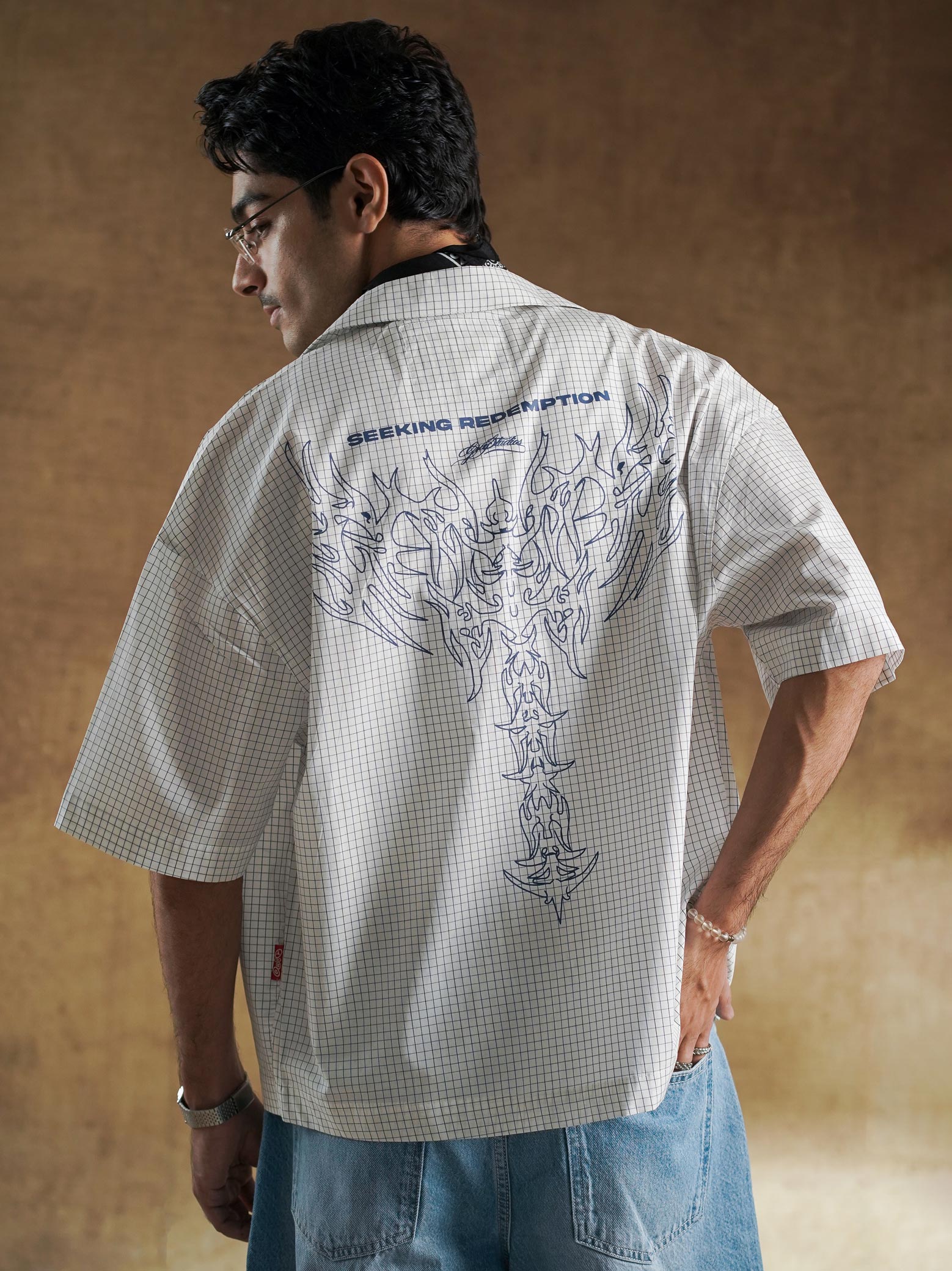 Twin tribal chest motifs on woven grid check - GROOVY Pakistan